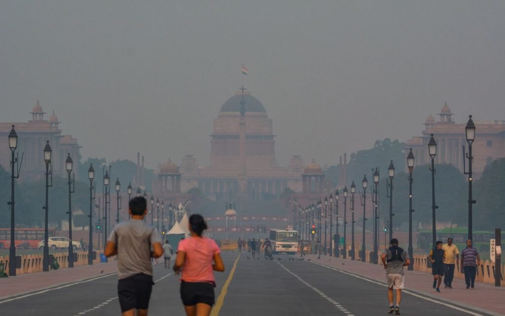 People jogging on a smoggy morning on Kartavya Path near Rashtrapati Bhavan, New Delhi