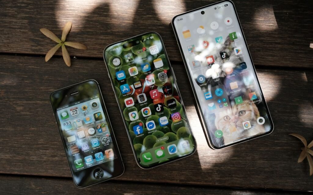 buy a phone now or wait: three phones of different generations on a table