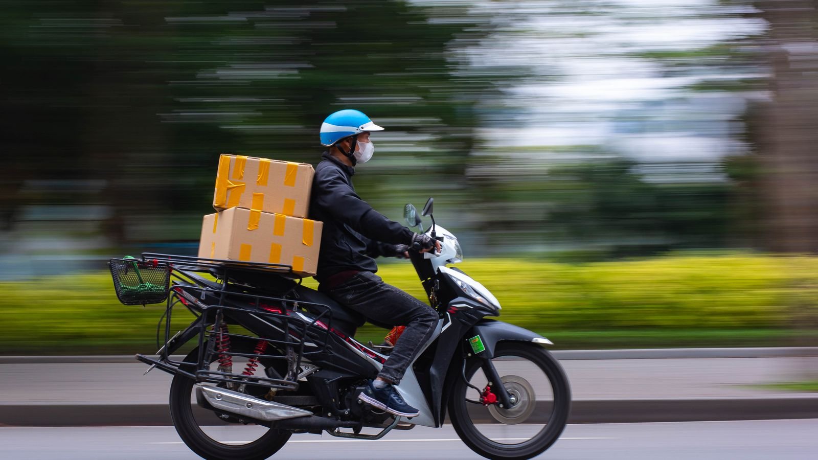 Buying a phone on Blinkit: delivery rider speeding on a motorbike with parcels