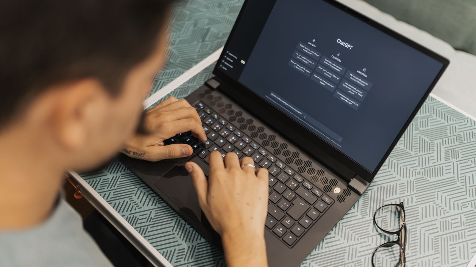 chatgpt chrome extension: man typing on a laptop with ChatGPT open