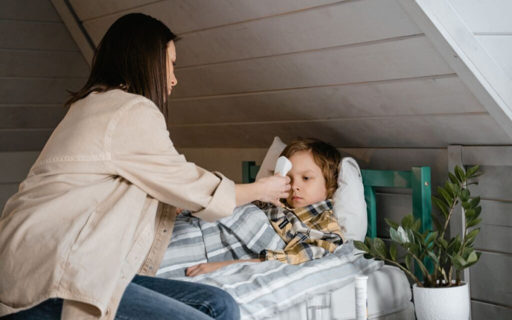 Mother caring for her sick son in bed