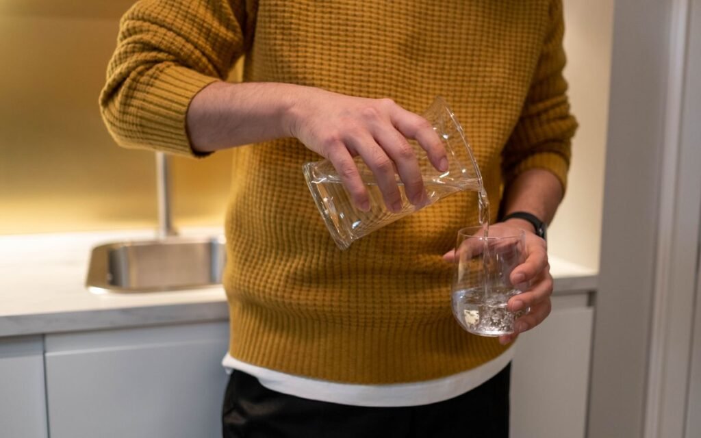 water being poured into a glass in a kitchen