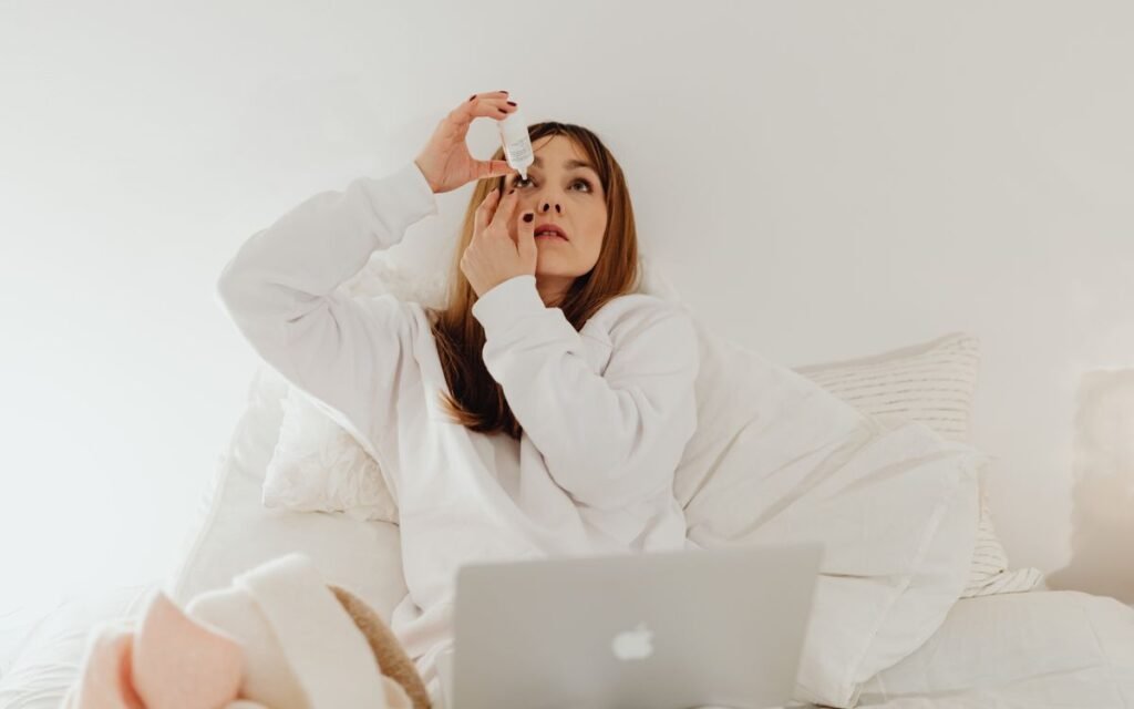 woman putting in eye drops