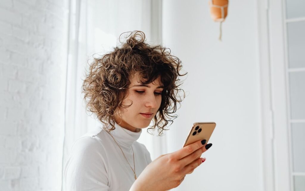 fake delivery sms: a woman reading a message on her phone