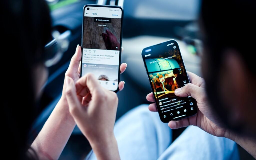 two people holding two different smartphones side by side