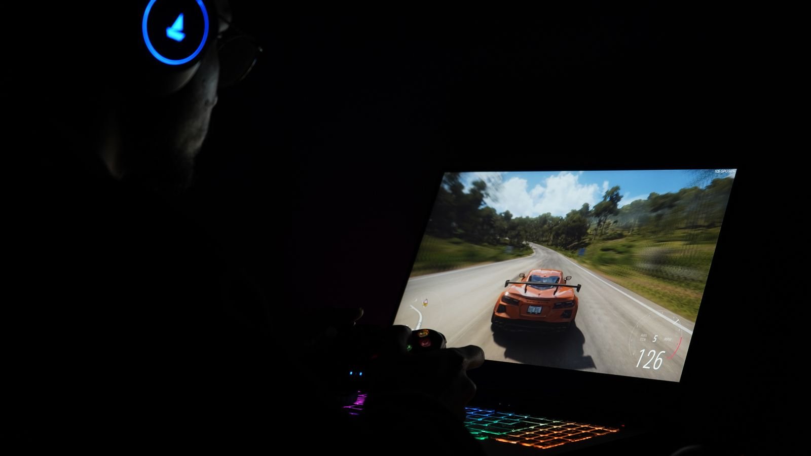 geforce now india: a gamer playing a racing game on a laptop