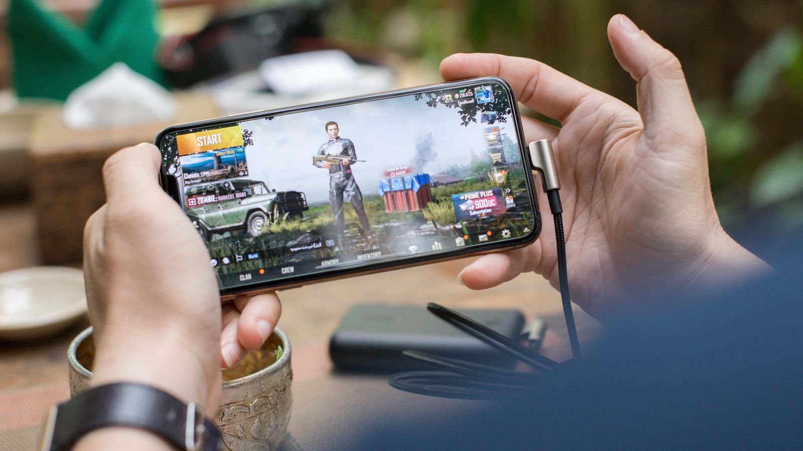 infinix gt 50 pro: hands holding a phone sideways while playing a mobile game