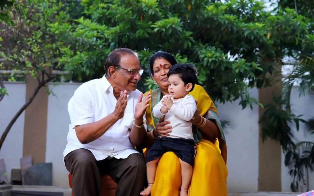 Indian grandparents with their grandson in a garden
