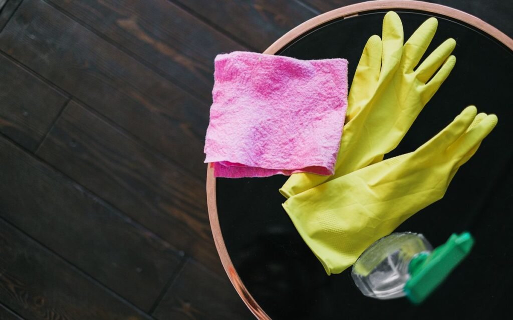 rubber gloves, a cloth and a spray bottle