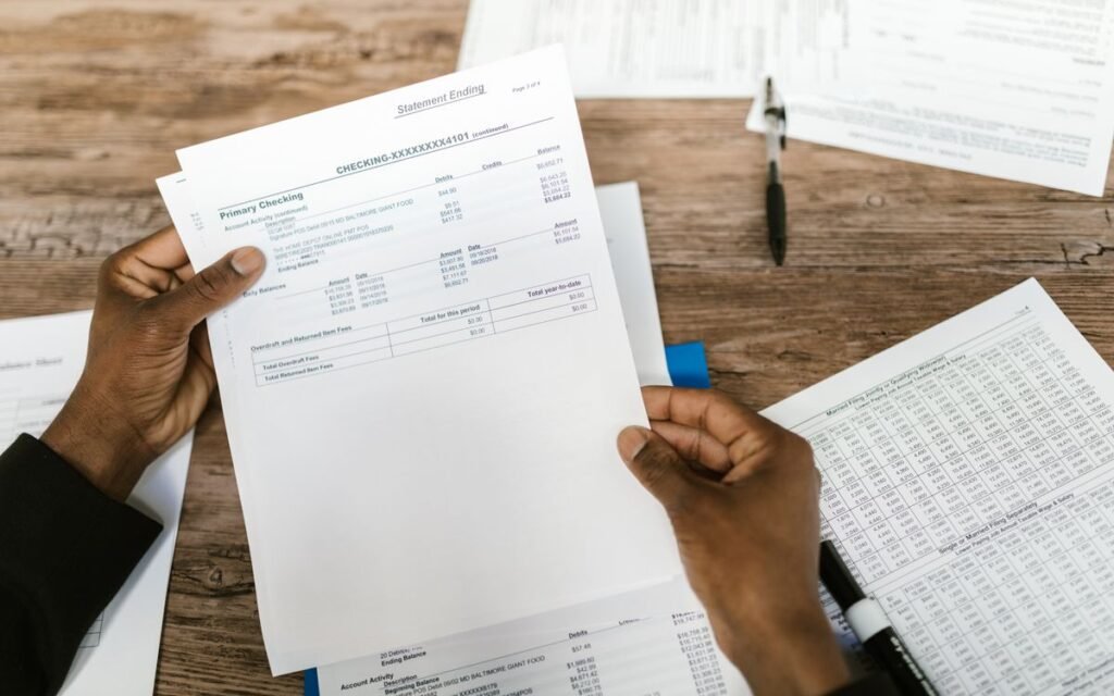 money missing from bank account: hands holding a printed account statement
