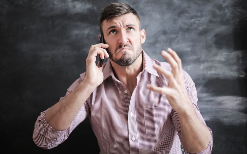Frustrated man taking a phone call