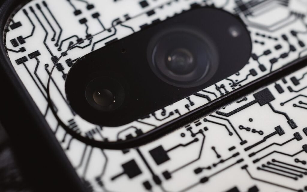 macro close-up of a smartphone camera lens on a patterned phone back