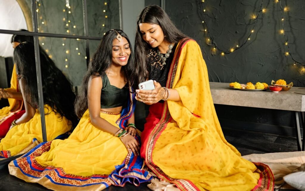 two women looking at festive photos on a phone